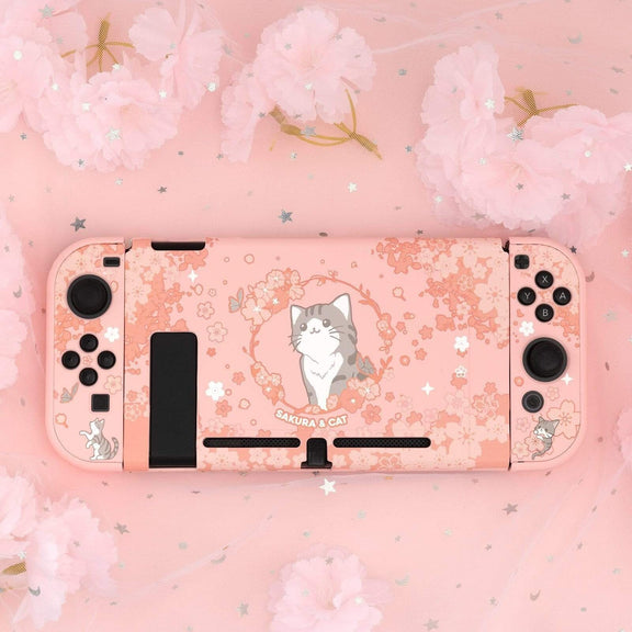 Pink Nintendo Switch case featuring delicate cherry blossoms and an adorable gray cat, adding a touch of charm and style to your gaming setup.