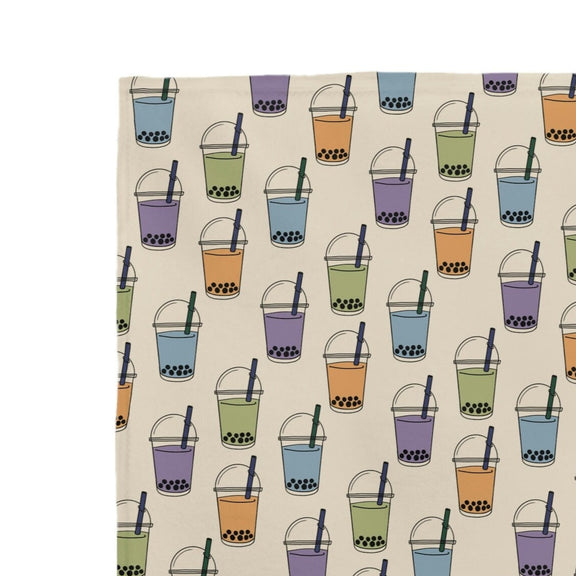 Tan blanket adorned with delightful boba milk tea cup designs - a cozy and charming addition to your home decor